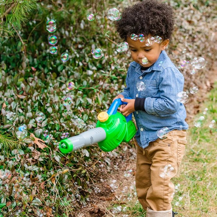 Kid playing with a Maxx Bubbles bubble leaf blower